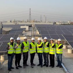 Zoetis GMS colleagues on roof with solar panels - Zoetis
